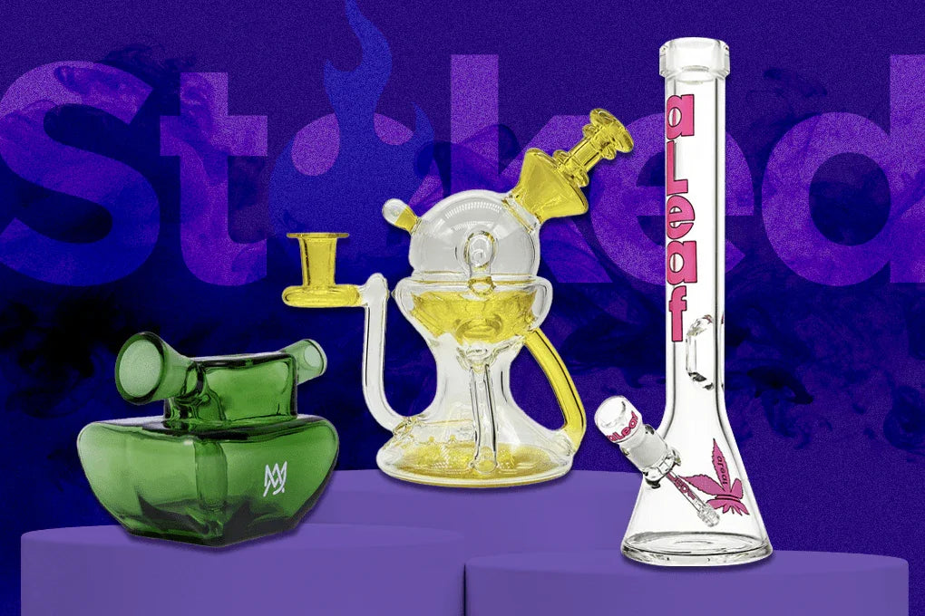 Three artistic glass water pipes and bongs in green, yellow, and clear glass on a purple background.