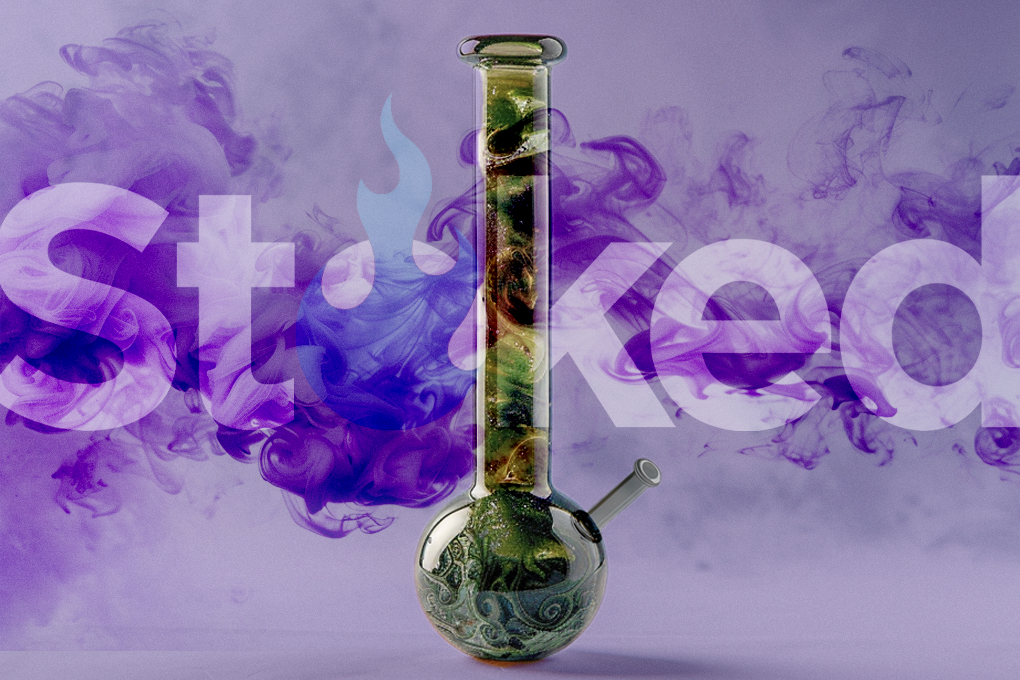 Multicolored glass bong on a smokey purple background.
