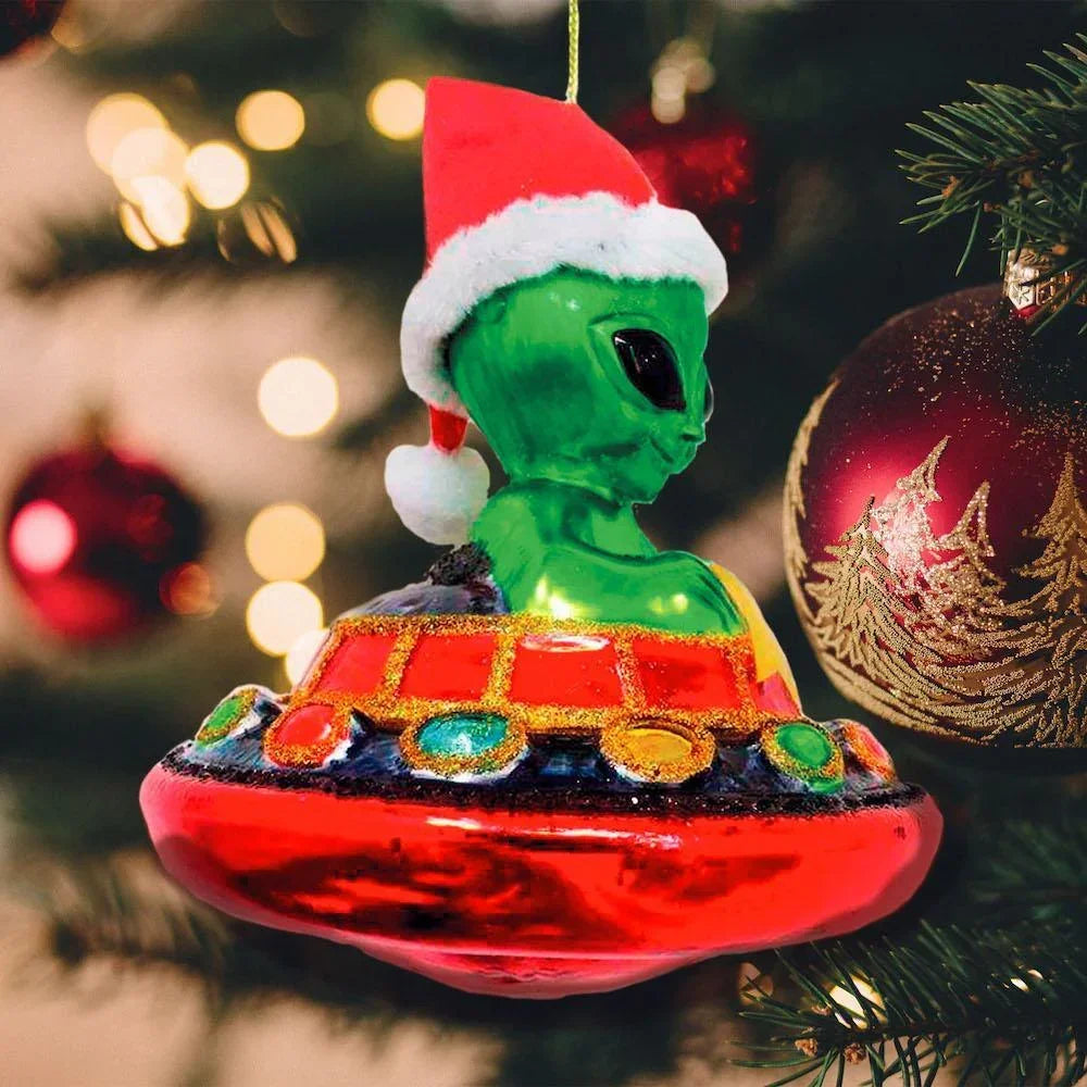 Alien in Santa hat UFO Christmas ornament hanging on decorated tree