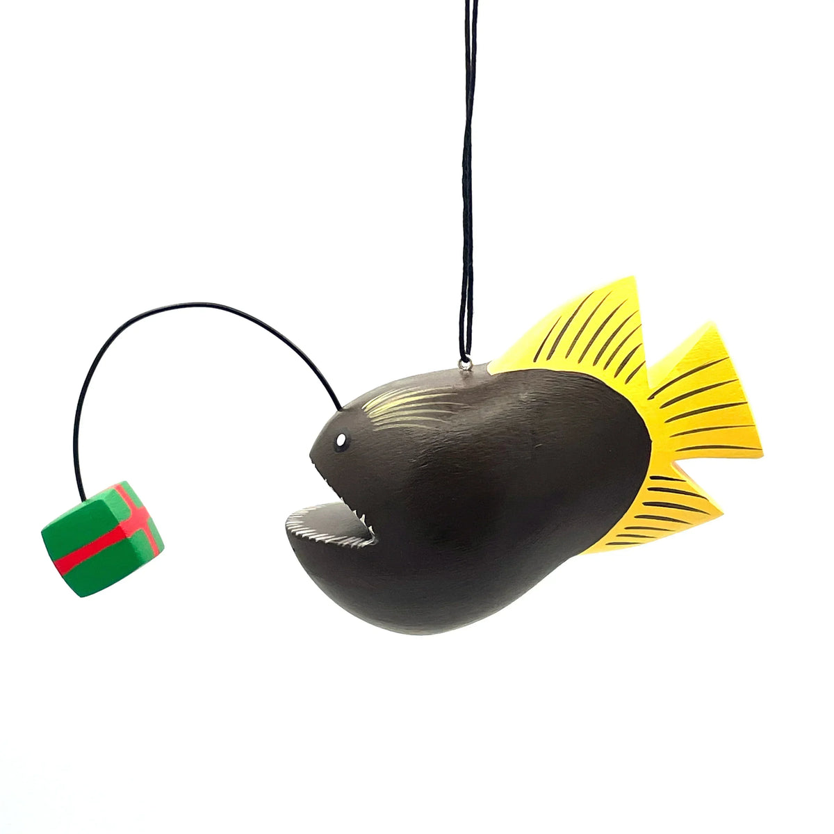 Anglerfish ornament with yellow fins and a green gift lure on a white background