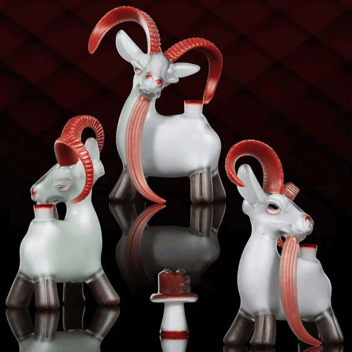 Heady glass goat-shaped water pipes with red horns displayed on black background