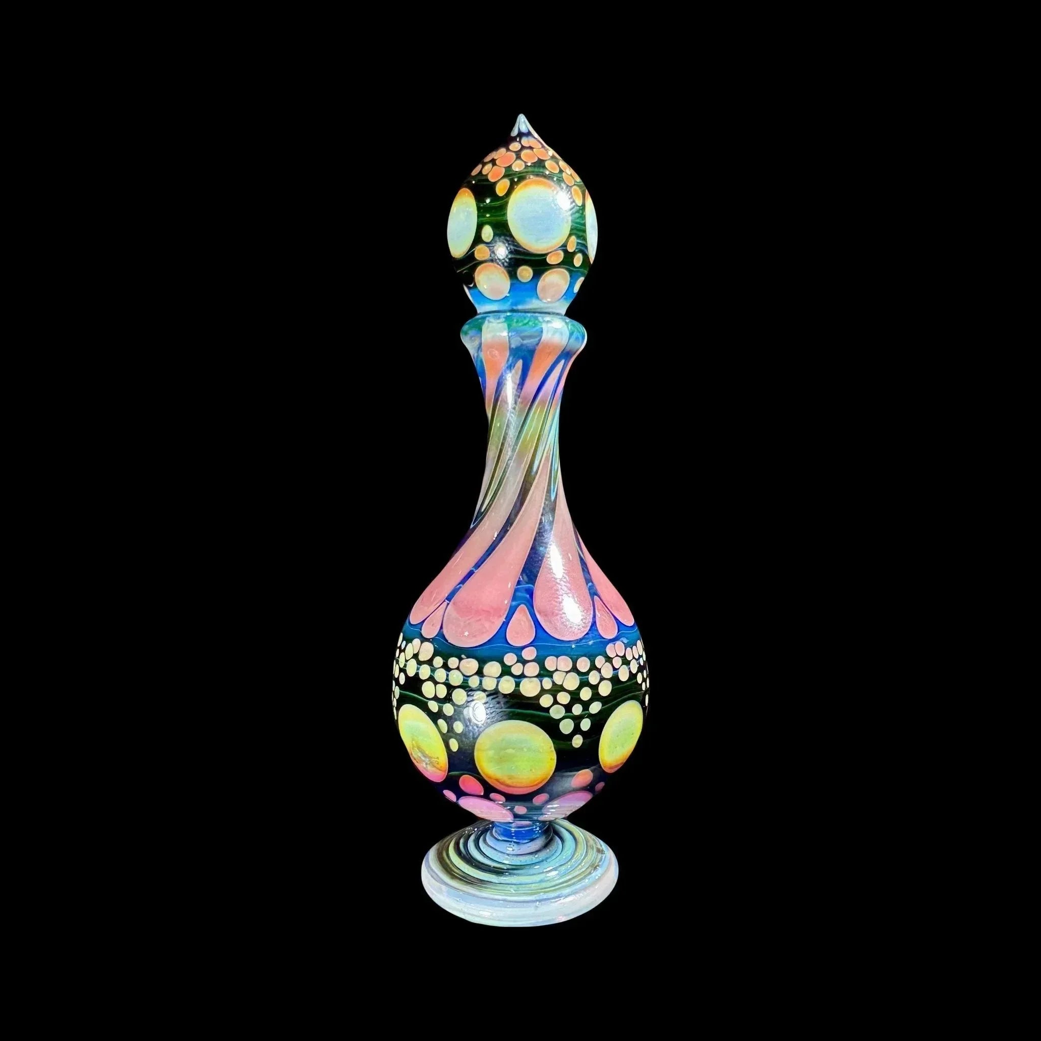 Colorful heady glass art bottle with swirling patterns and dot accents on black background