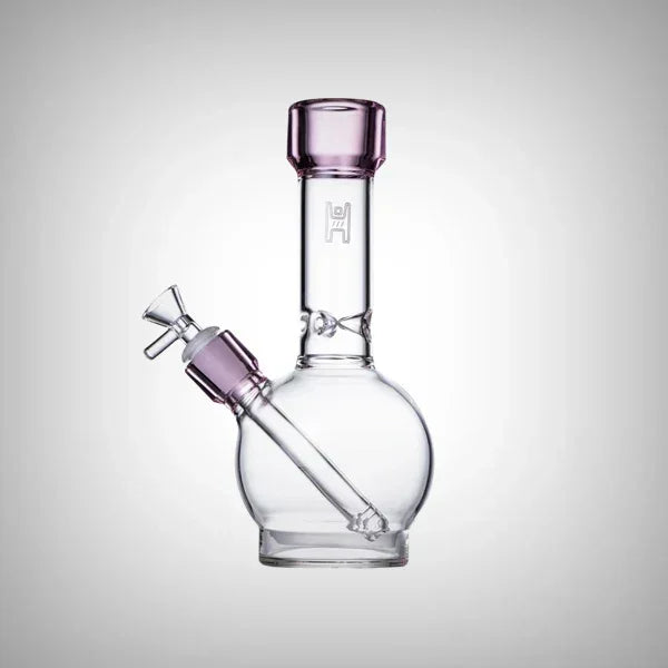 Clear glass water pipe with purple accents and round base on white background