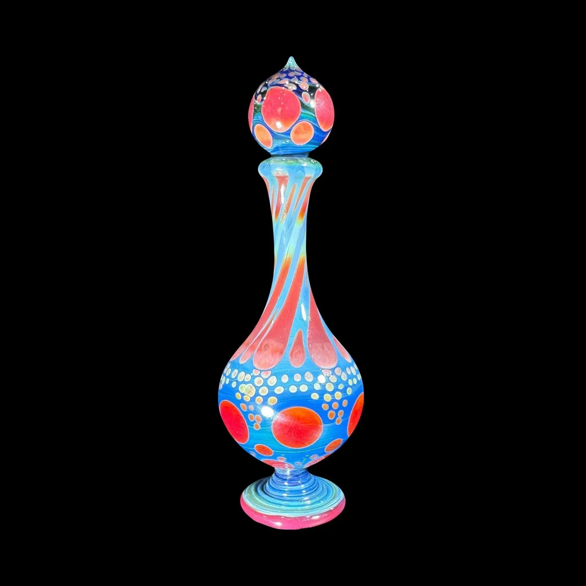 Colorful heady glass art piece with red, orange, and blue patterns on black background