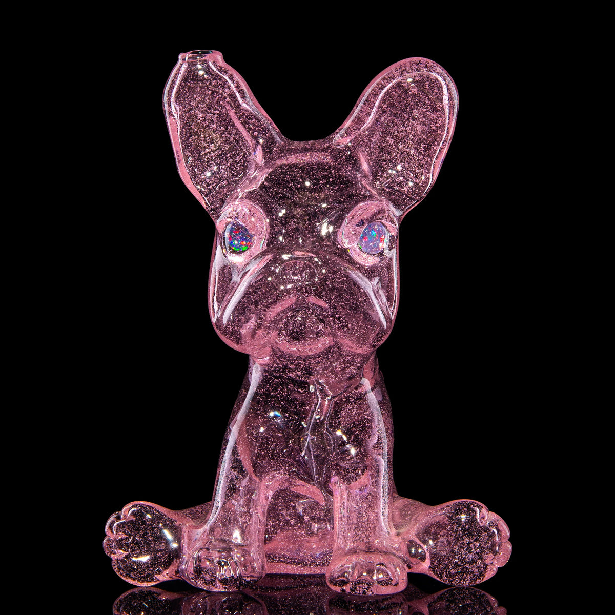 Pink hand-blown glass dab rig with a frenchie design by Swanny