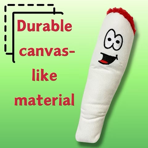 Plush toy with smiling face, red top, and durable canvas-like material on green background.