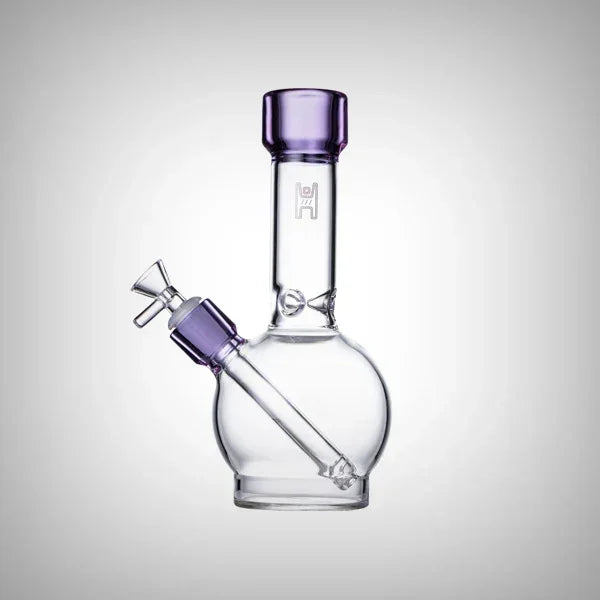 Clear glass water pipe with purple accents and round base on white background