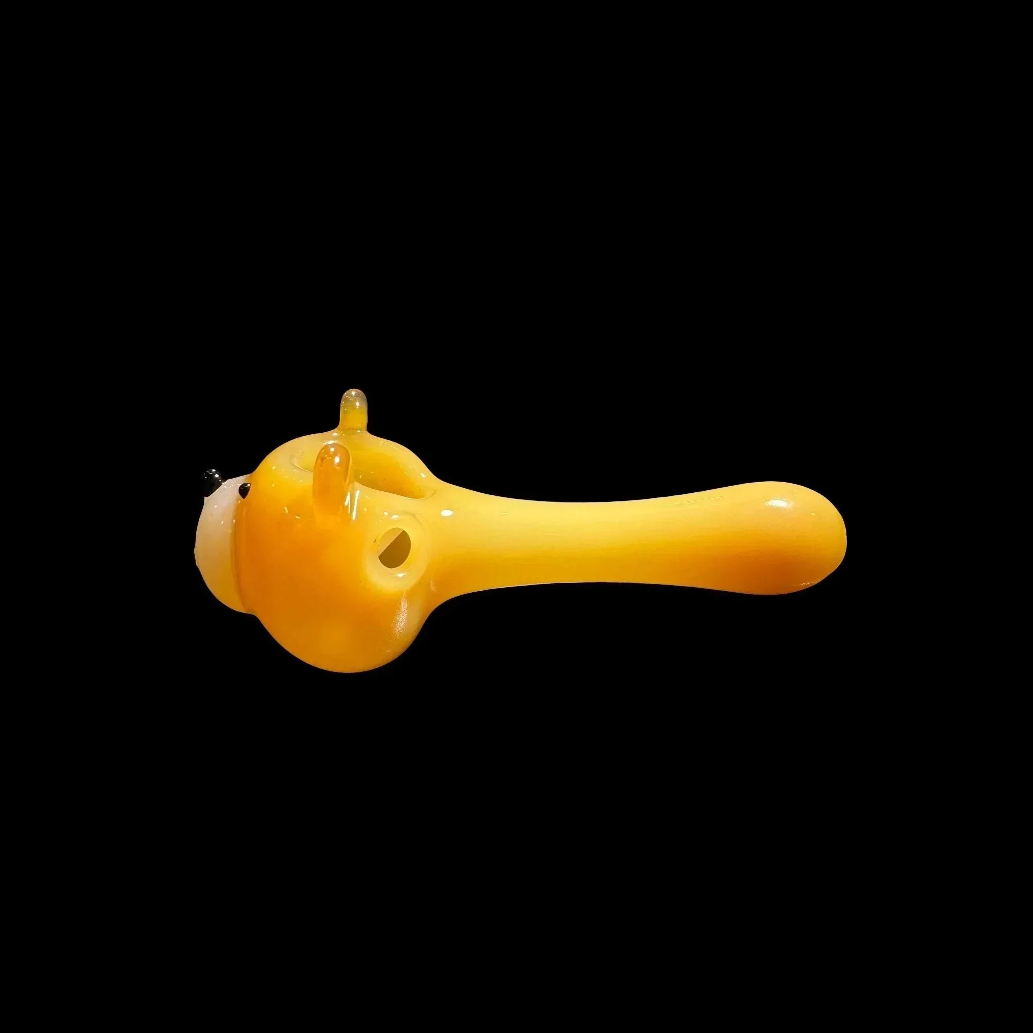 Yellow character-shaped glass hand pipe with ears on black background