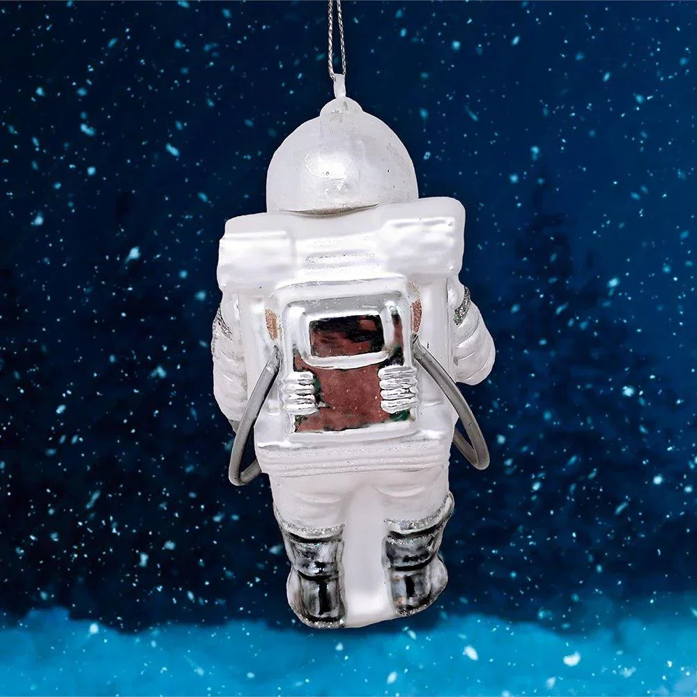 Astronaut ornament with backpack hanging in space-themed background, glass decor