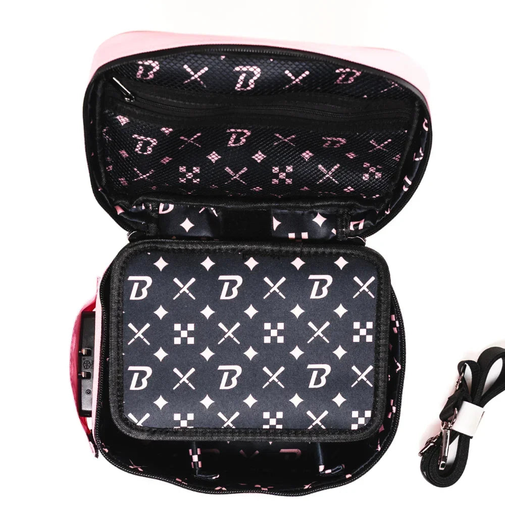Open carrying case with black and pink patterned interior and detachable strap