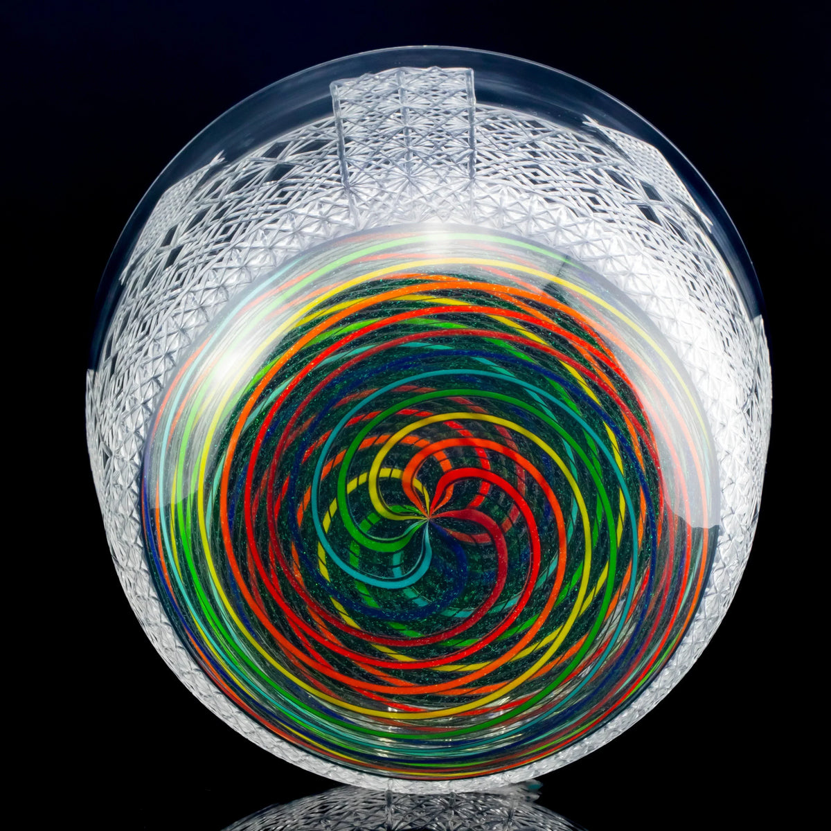 intricate heady glass art piece with multicolor spiral pattern and etched geometric design