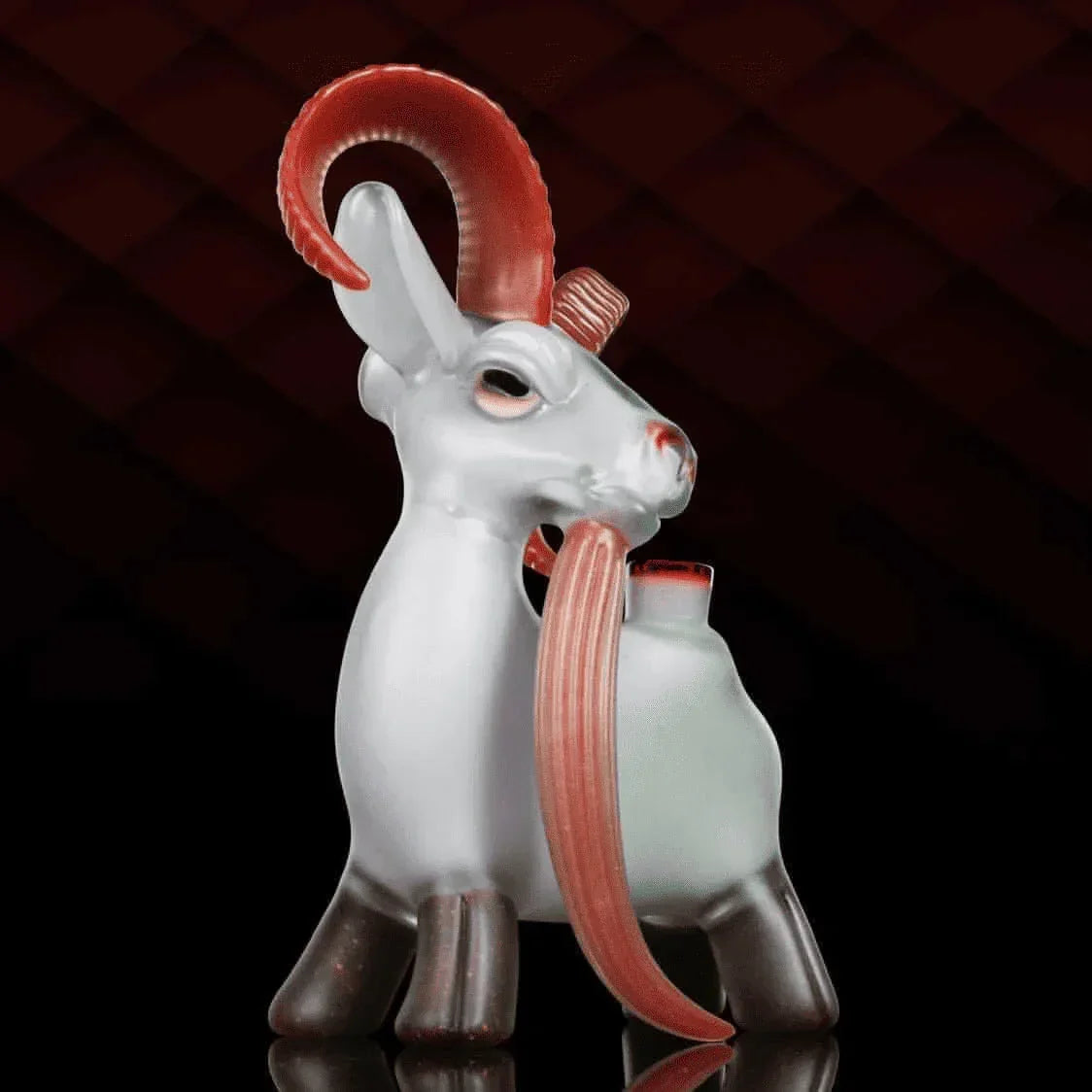 Glass goat sculpture with red horns and a curved mouthpiece, artisan glass smoking accessory.