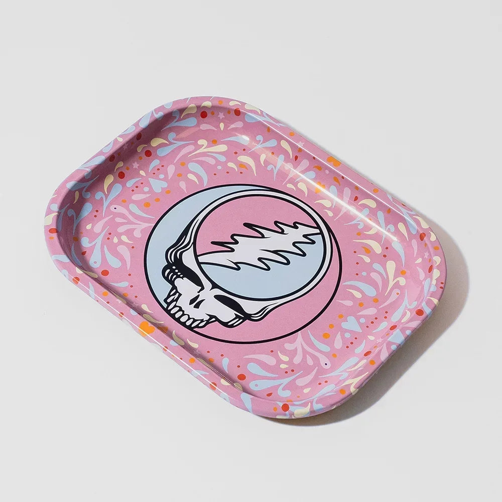 Pink rolling tray with colorful splash pattern and skull graphic, smoke shop accessory