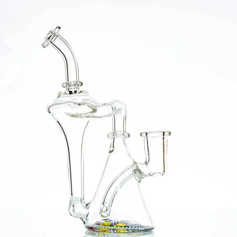 Clear glass recycler water pipe with intricate design and colorful base, isolated on white background