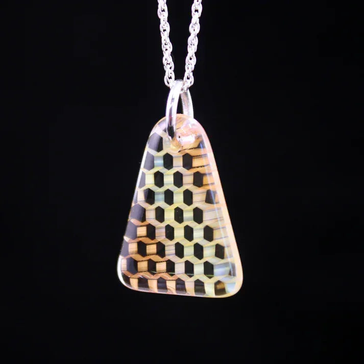 Geometric glass pendant necklace with hexagon pattern on silver chain, black background
