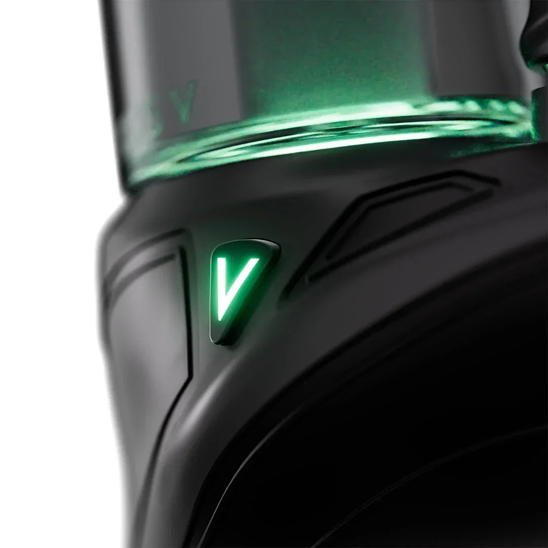 Close-up of a sleek black vaporizer with a glowing green V-shaped LED indicator