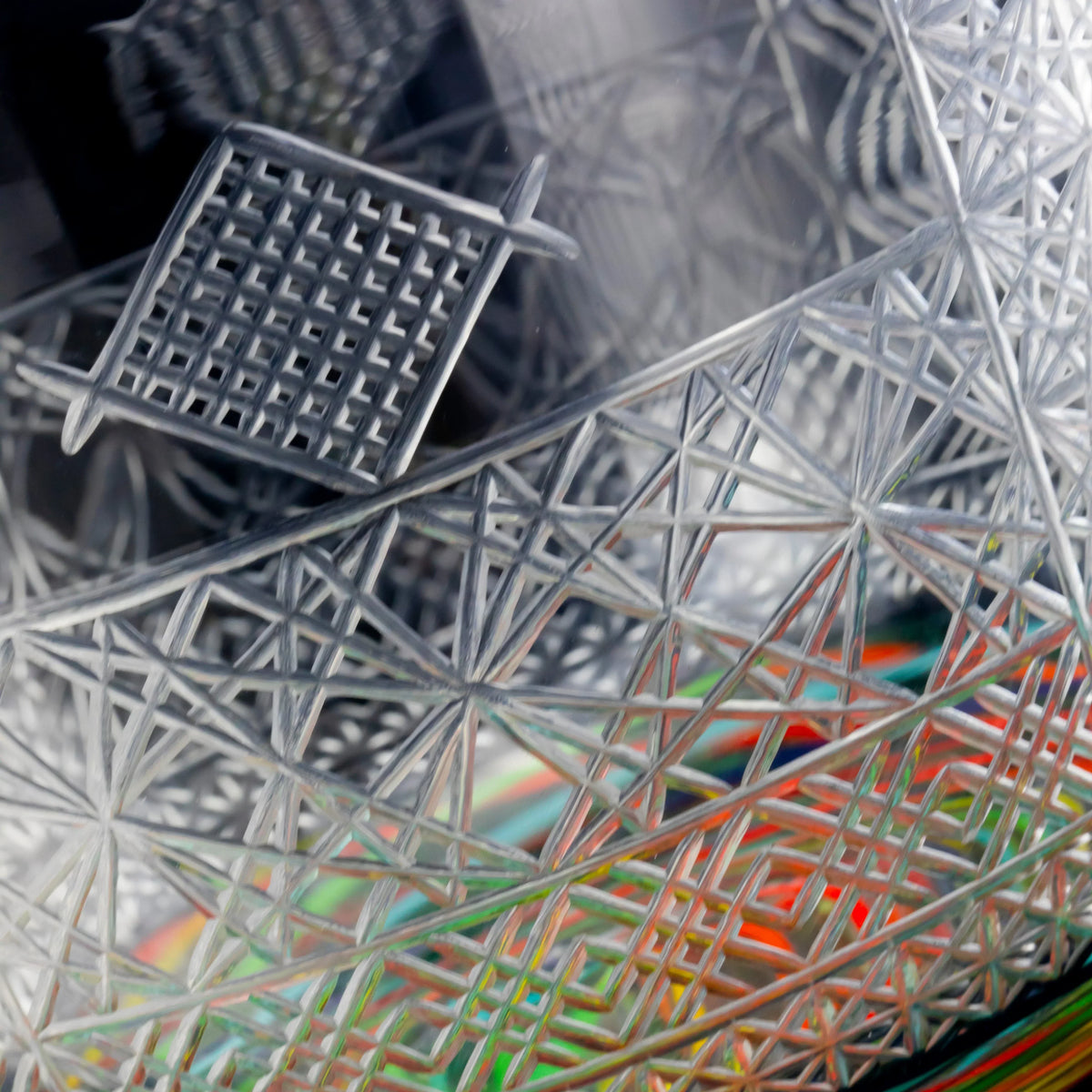 Close-up of intricate heady glass art with geometric patterns and etched details