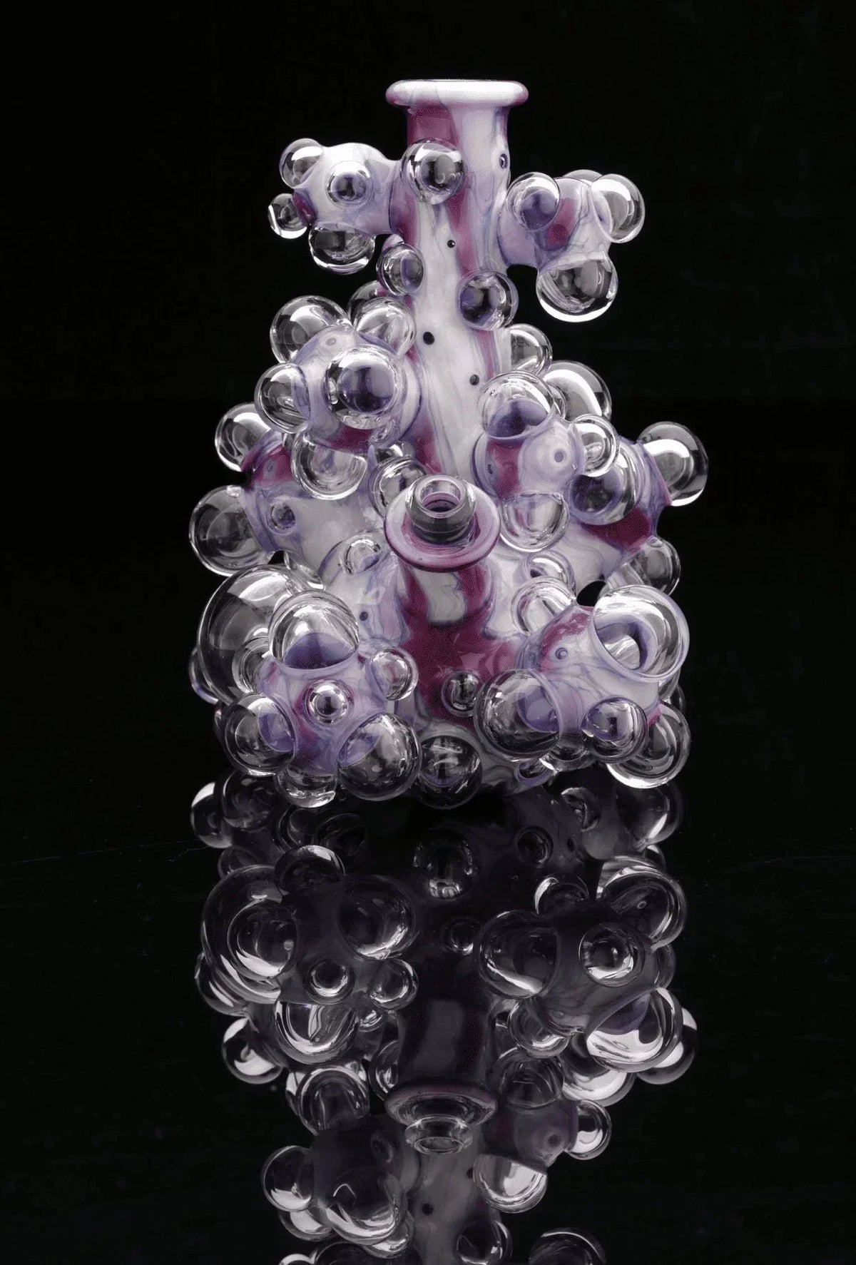 Heady glass water pipe with purple and clear bubble accents on black background