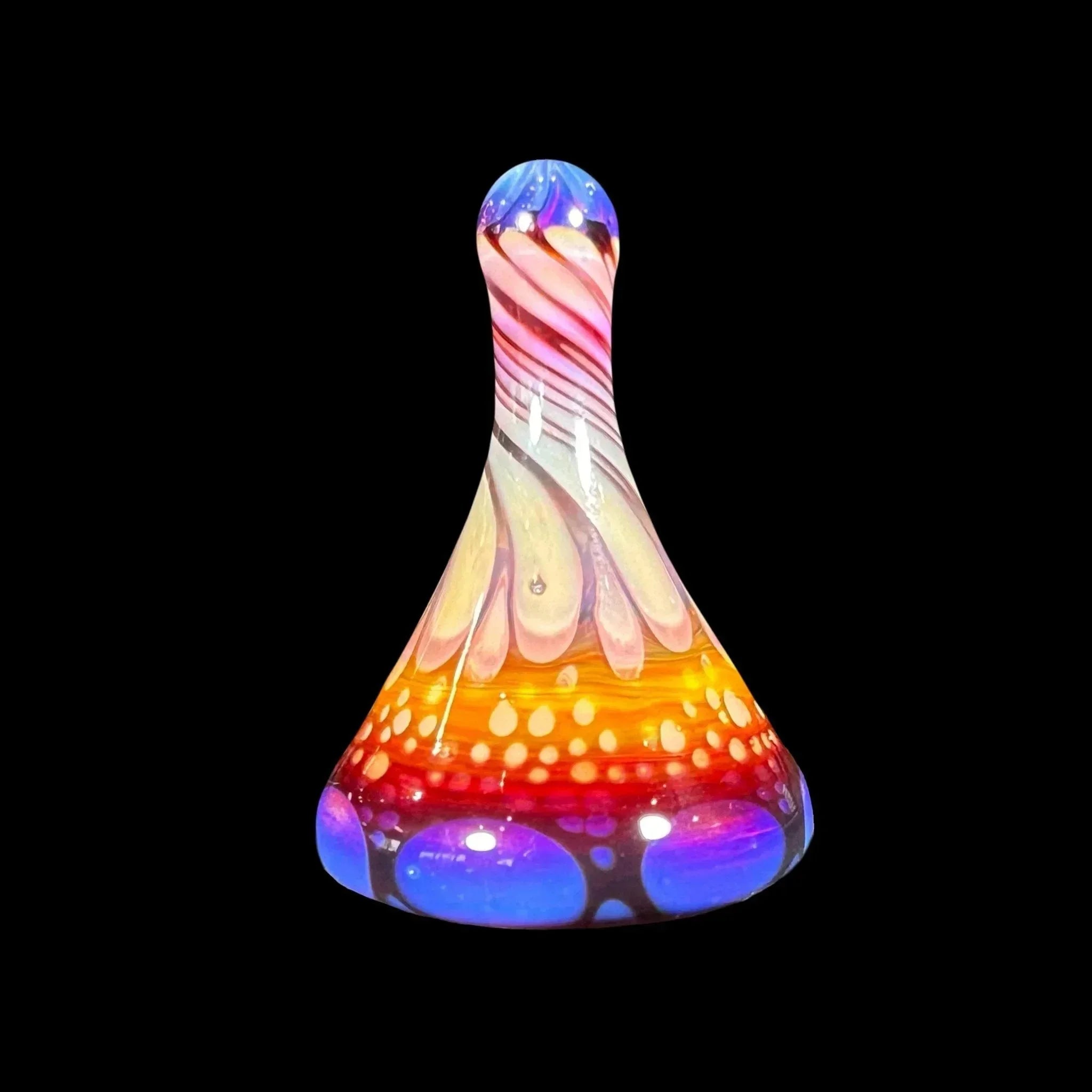 Colorful hand-blown glass carb cap with swirled rainbow design on black background.