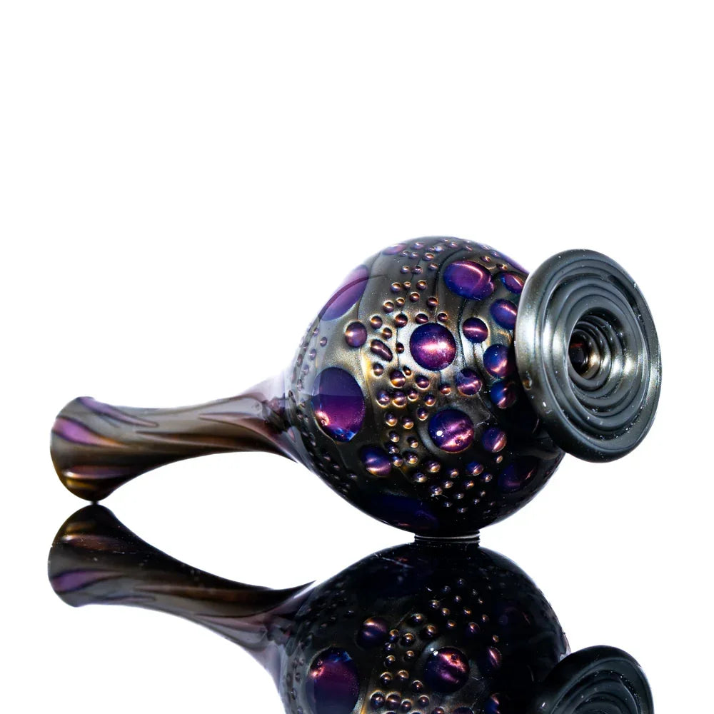 Colorful glass hand pipe with metallic bubble accents and reflective surface