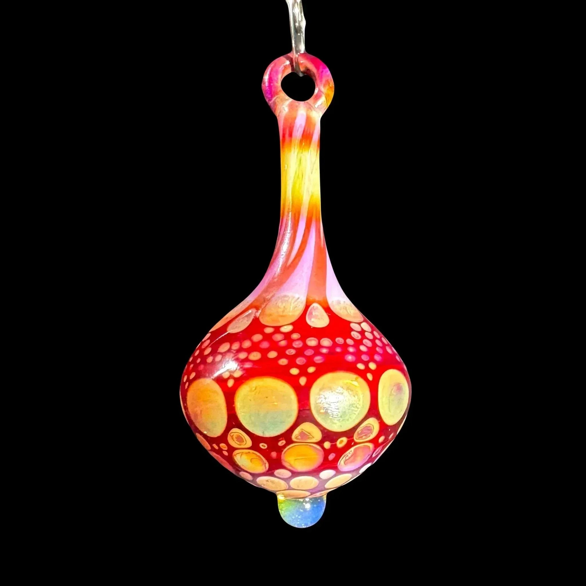 Hand blown glass pendant with vibrant red, yellow, and orange dot pattern on black background