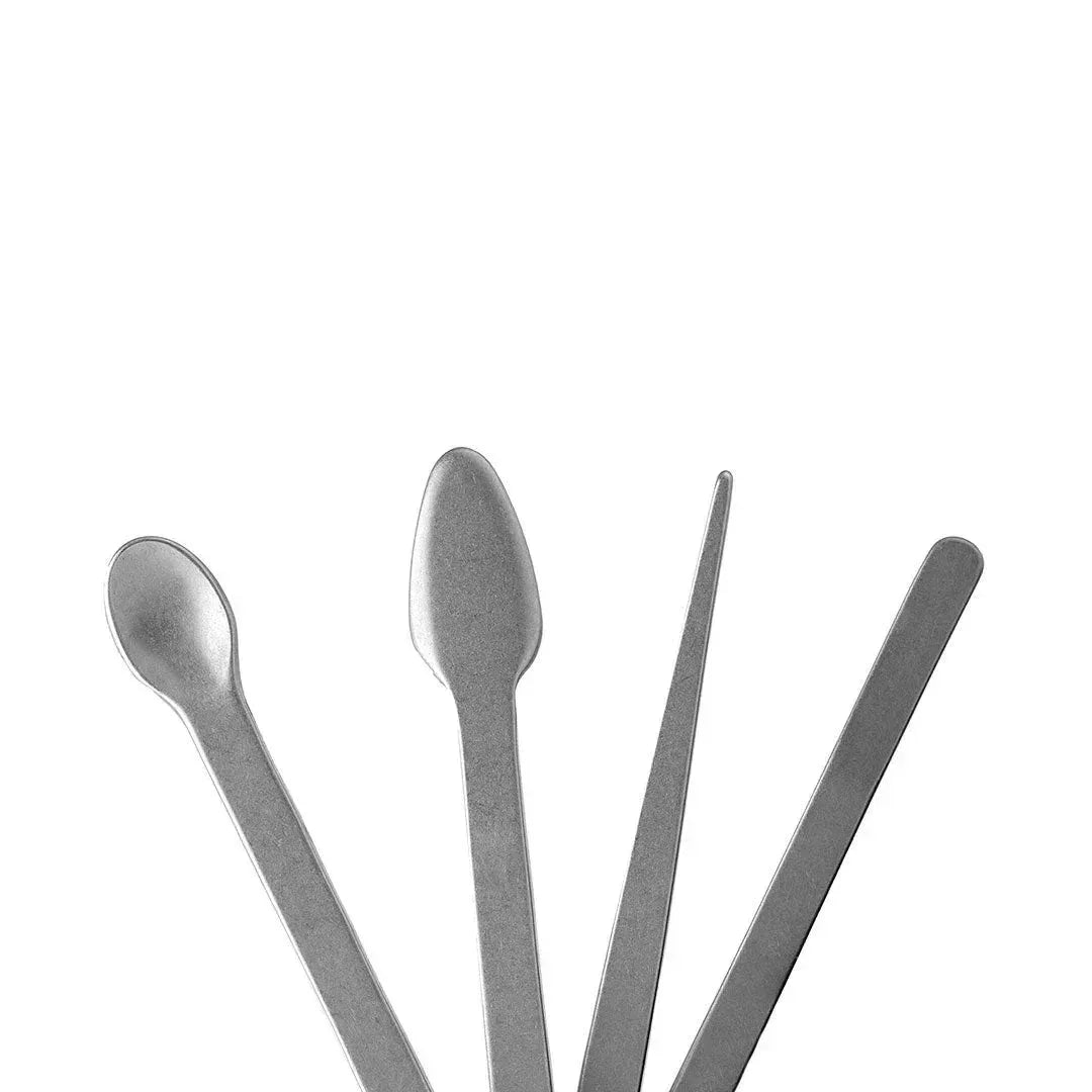 Four metal dab tools with different shaped tips on white background, smoking accessories