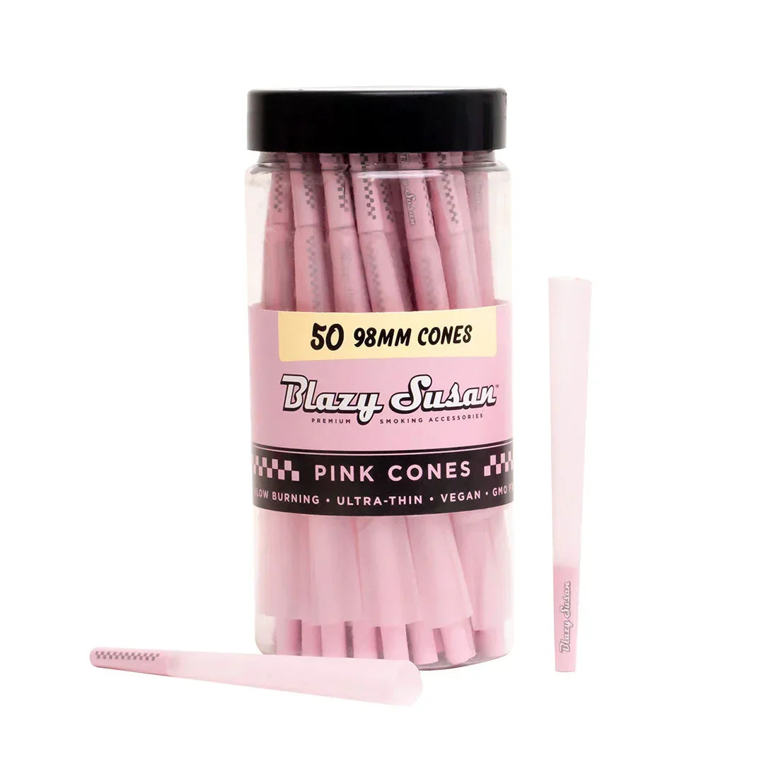 Jar of Blazy Susan pink 98mm pre-rolled cones with two pink cones beside it