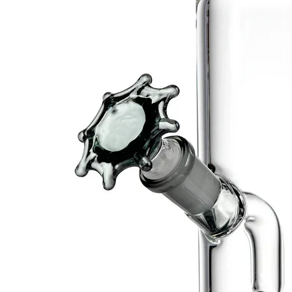 Clear glass bong with unique splash-shaped glass stopper and joint close-up