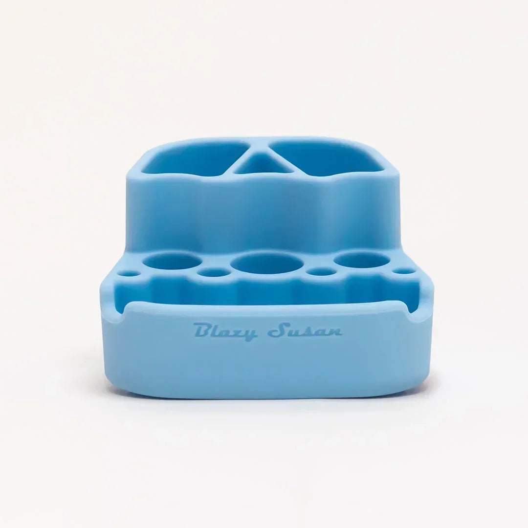 Light blue silicone smoking accessory organizer with multiple slots and 'Blazy Susan' text.