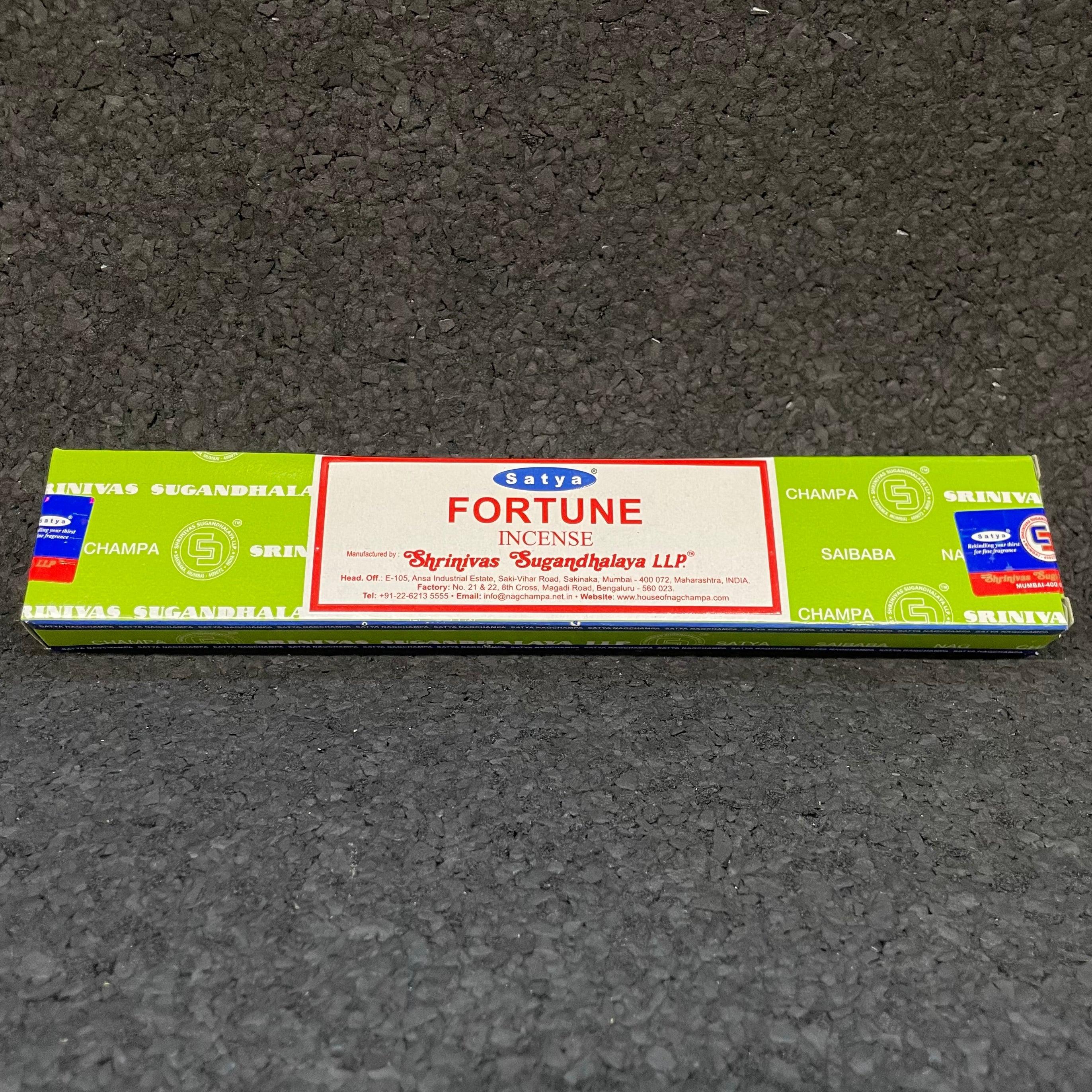 Satya Fortune incense box with green and white packaging on textured black surface