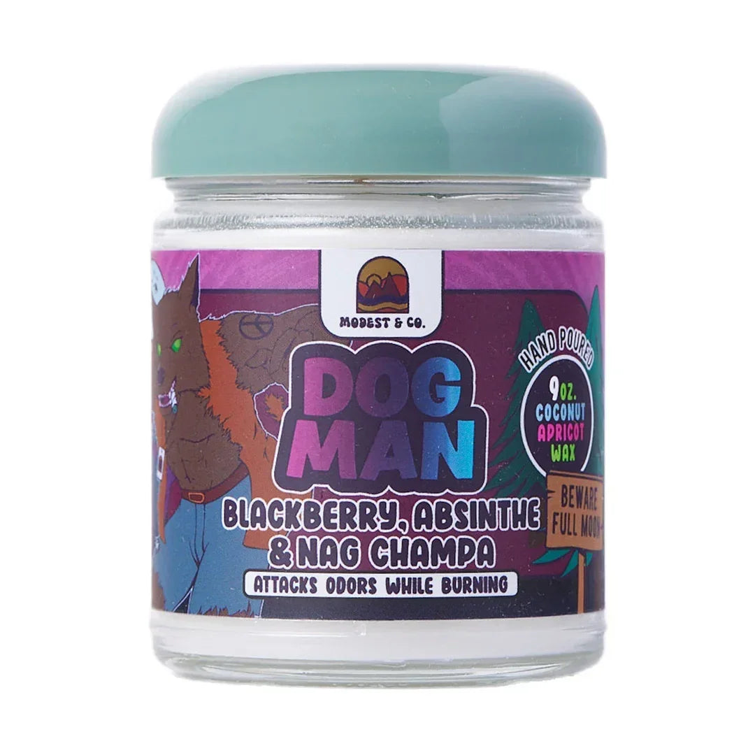 Dog Man scented candle jar with illustrated label, blackberry absinthe nag champa aroma.