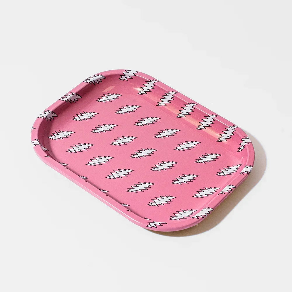 Pink metal rolling tray with white lightning bolt pattern on a white background