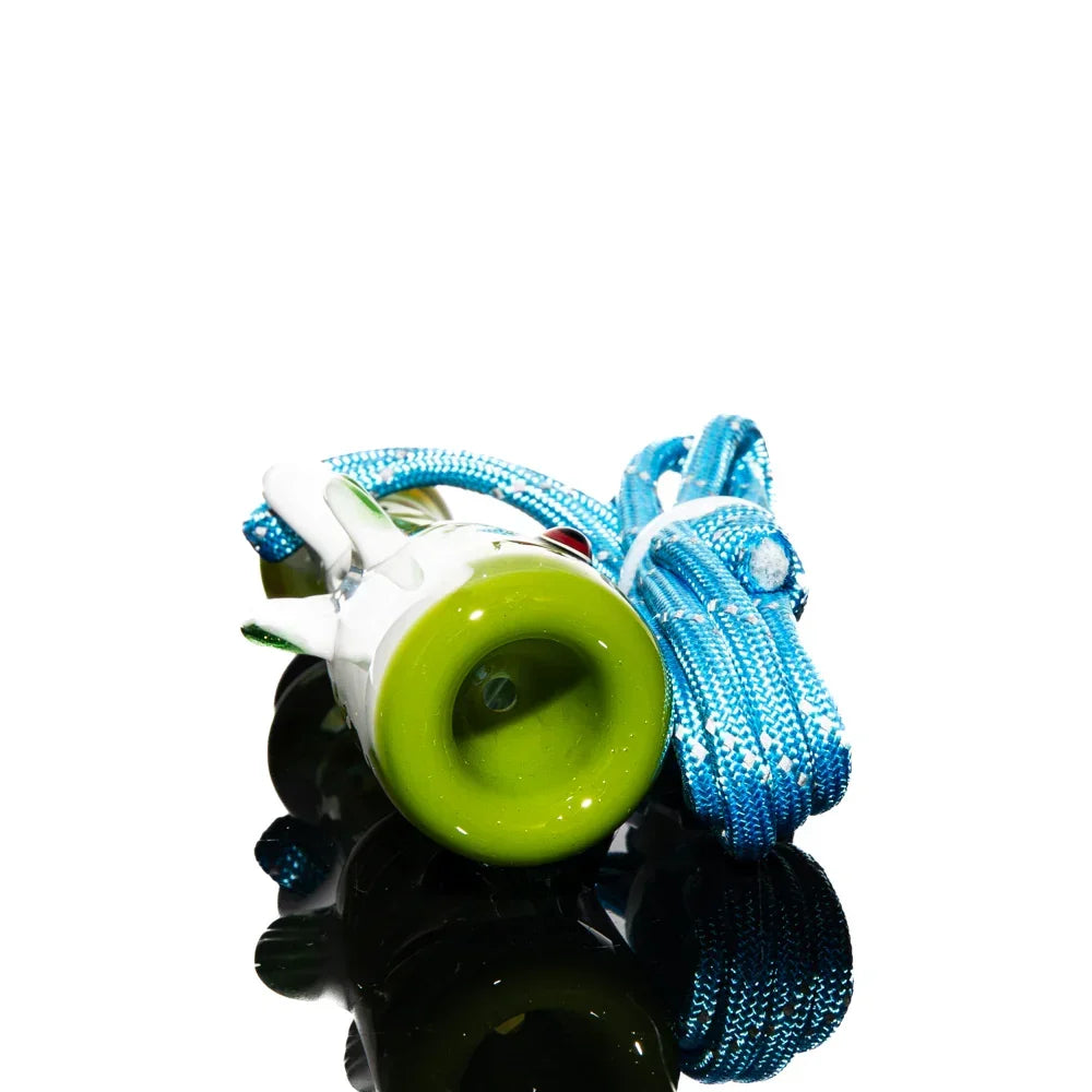 Green glass smallmouth bass fish whistle with blue lanyard on reflective surface