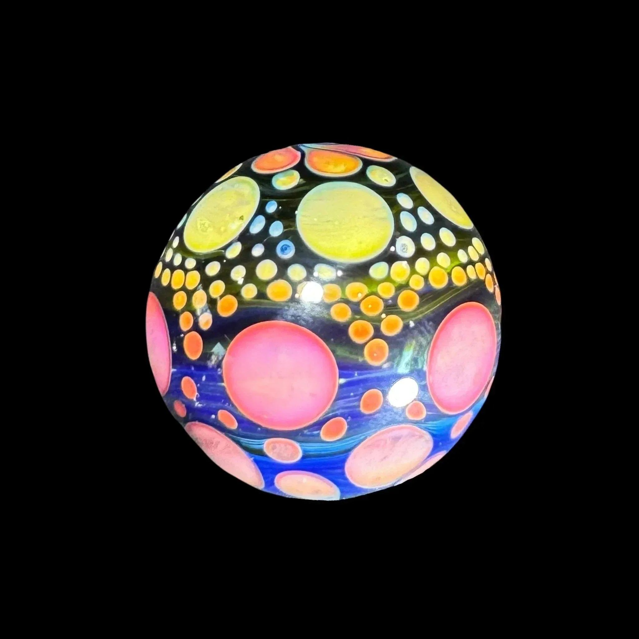 Heady glass marble with colorful bubble patterns, yellow, pink, and orange orbs on black background