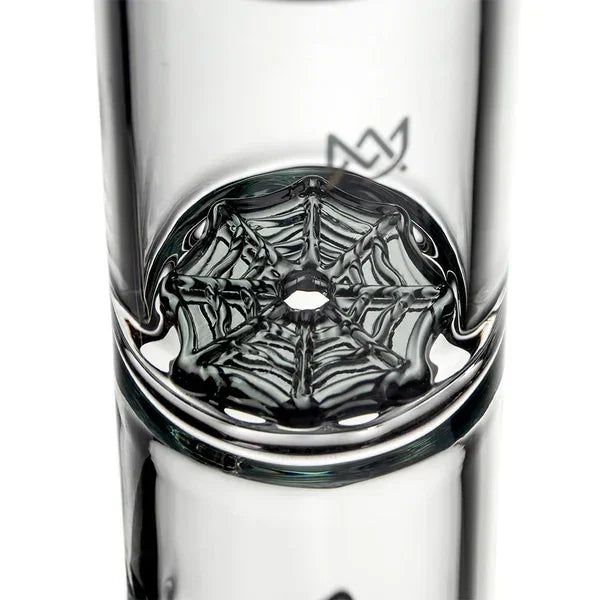 Close-up of clear glass bong with intricate spider web perc design inside