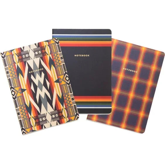 Set of three notebooks with geometric, striped, and plaid covers for stylish note-taking.