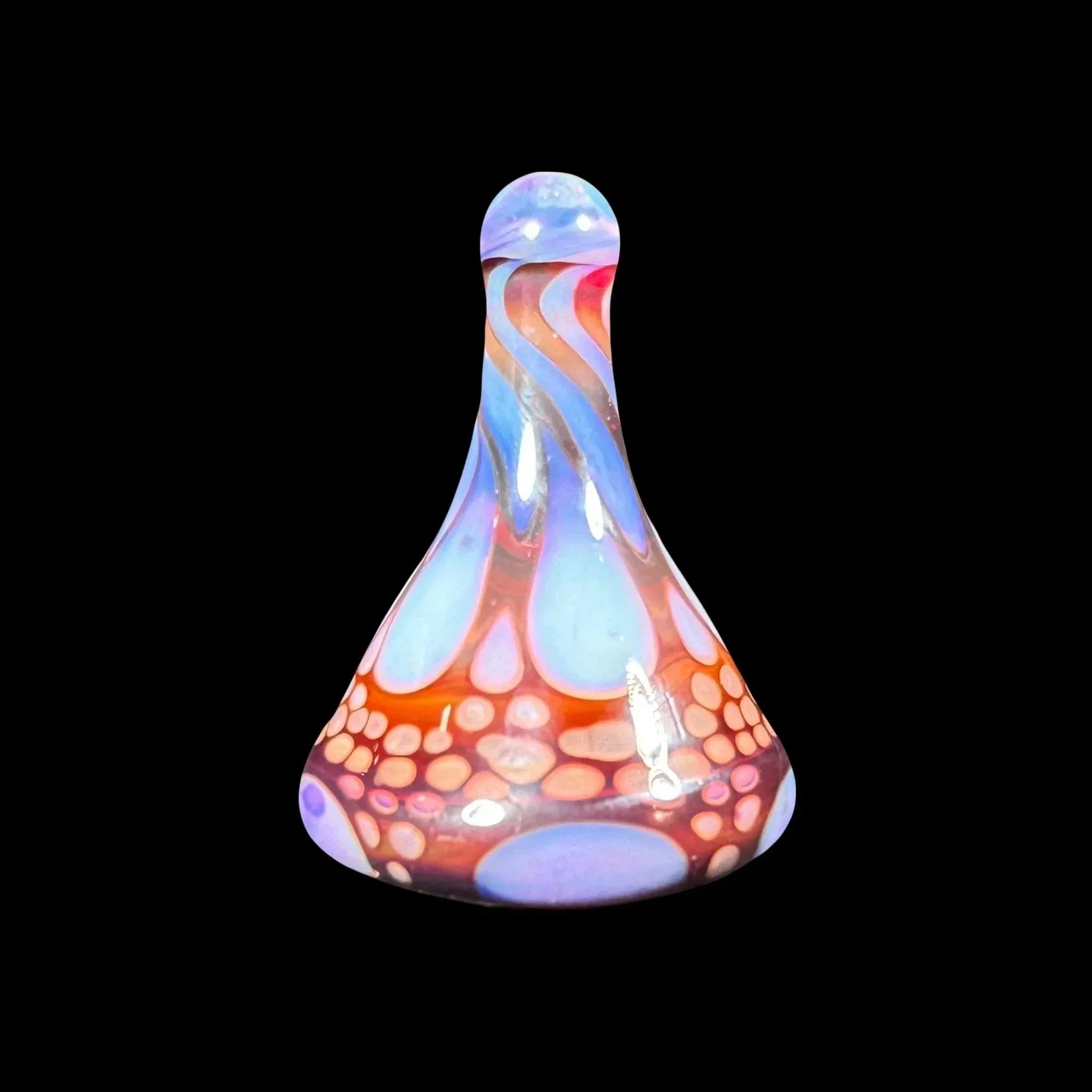 Colorful glass carb cap with swirling blue, red, and pink patterns on black background