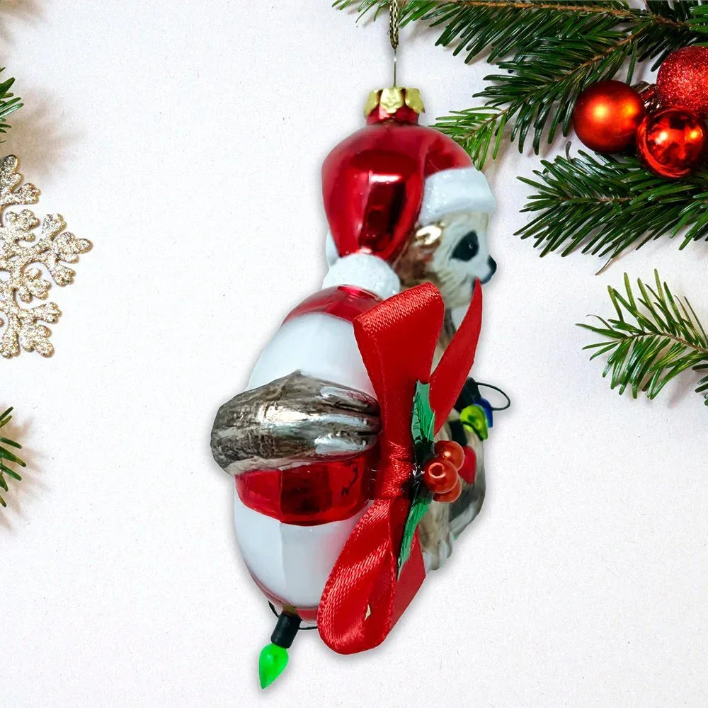 Christmas tree ornament shaped like a sloth in a Santa hat with red bow and festive decor