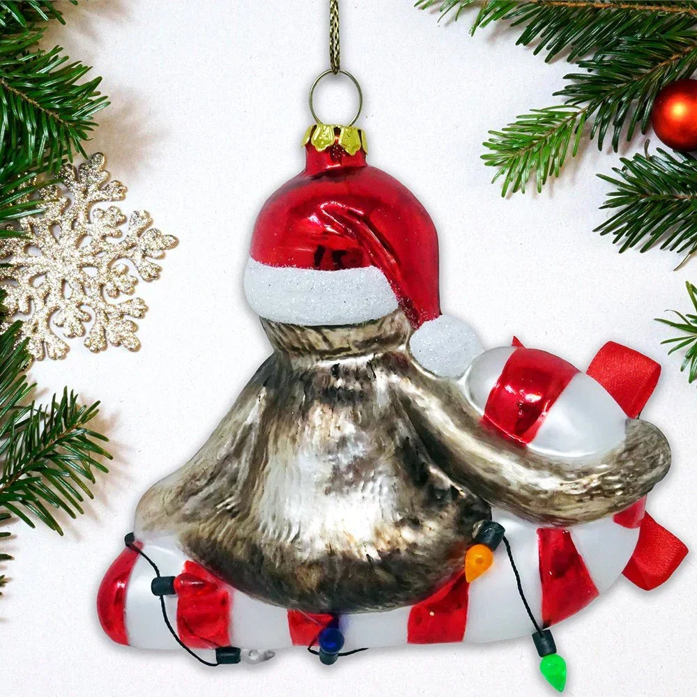 Hand-blown glass Christmas ornament shaped like a gnome with Santa hat and candy cane, festive holiday decor