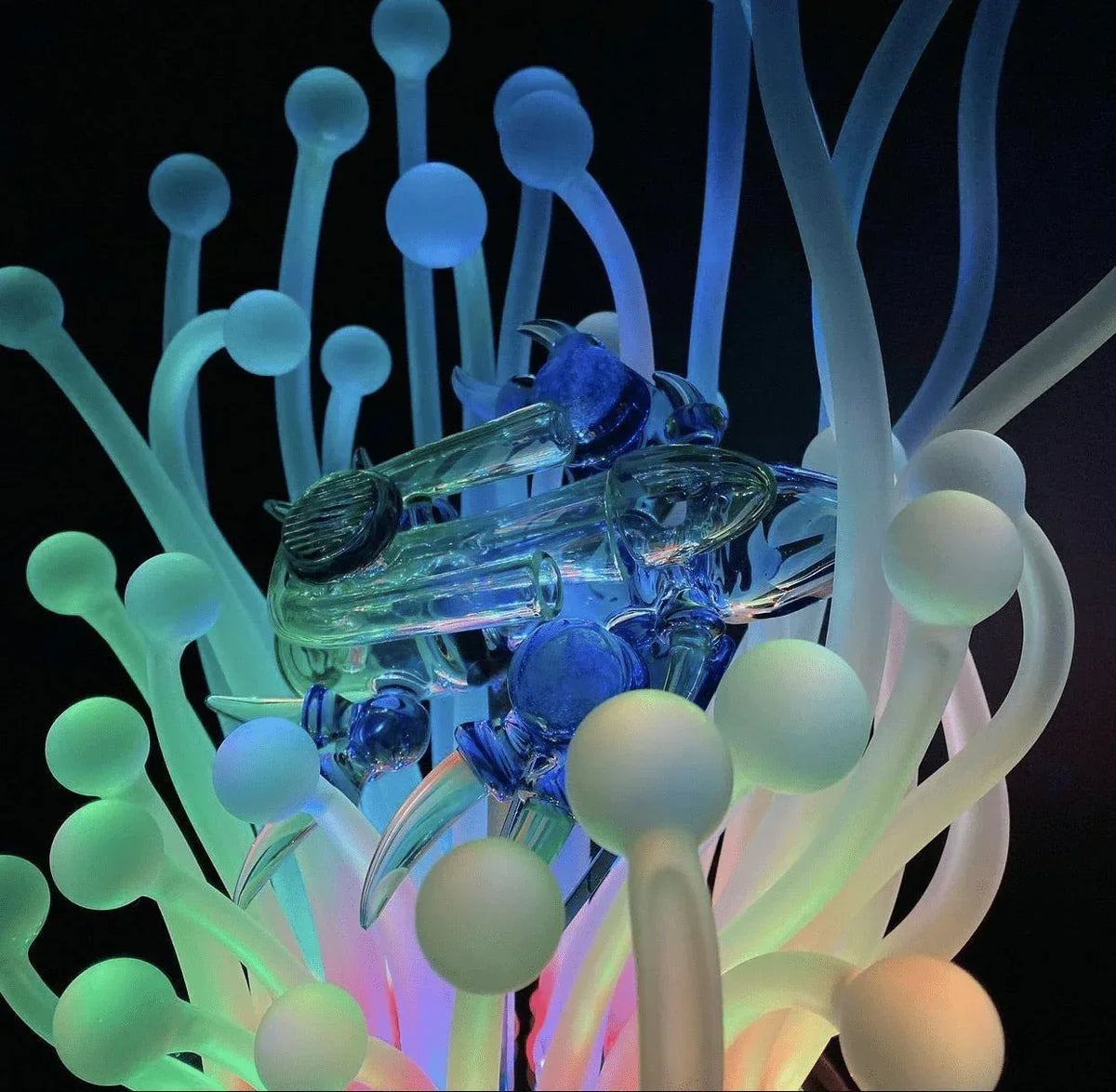 Artistic heady glass pipe with glowing colorful glass tentacles and spheres, smoke shop accessory