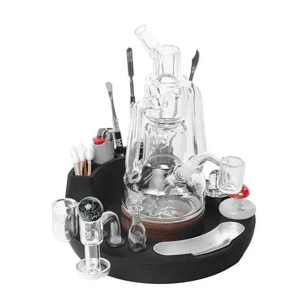 Glass dab rig with accessories, dab tools, and cotton swabs on an organized tray