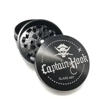 Black herb grinder with Captain Hook skull logo and text, open to show grinding teeth.