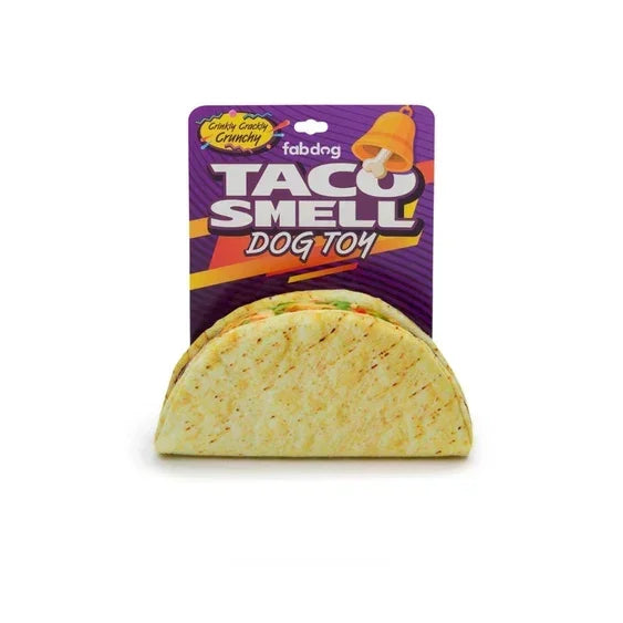 Taco-shaped plush dog toy with crunchy sound, labeled 'Taco Smell Dog Toy' in packaging.