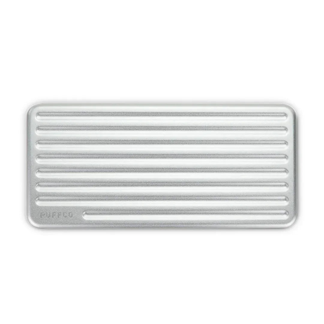 Rectangular silver metal tray with ridged surface, Puffco logo in corner, minimalist design