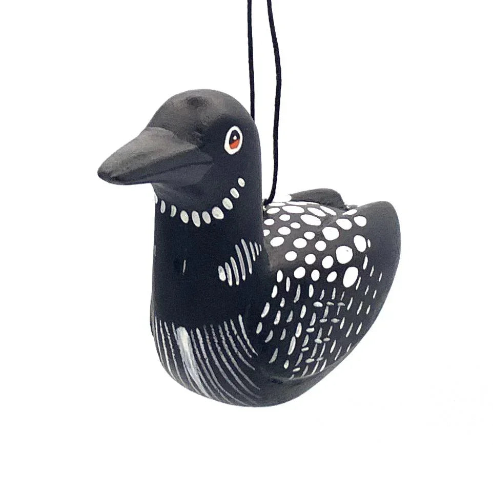 Handcrafted black and white bird ornament with polka dot and stripe details, hanging by string