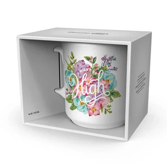 Ceramic mug with colorful floral design and 'Mighty High' text, displayed in gift box