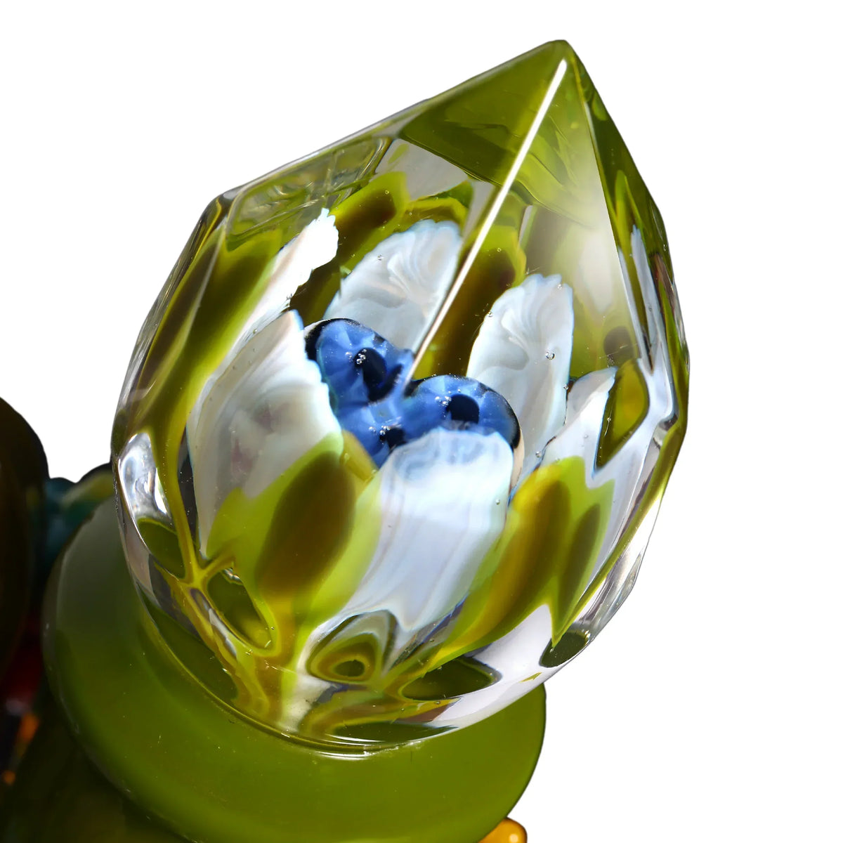 Close-up of artistic glass carb cap with green, white, and blue flower petal design