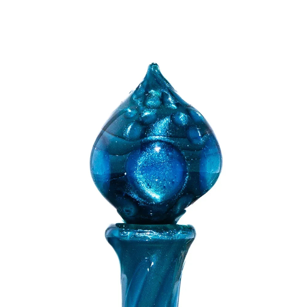 Blue glass carb cap with textured bubble accents for dab rigs on white background