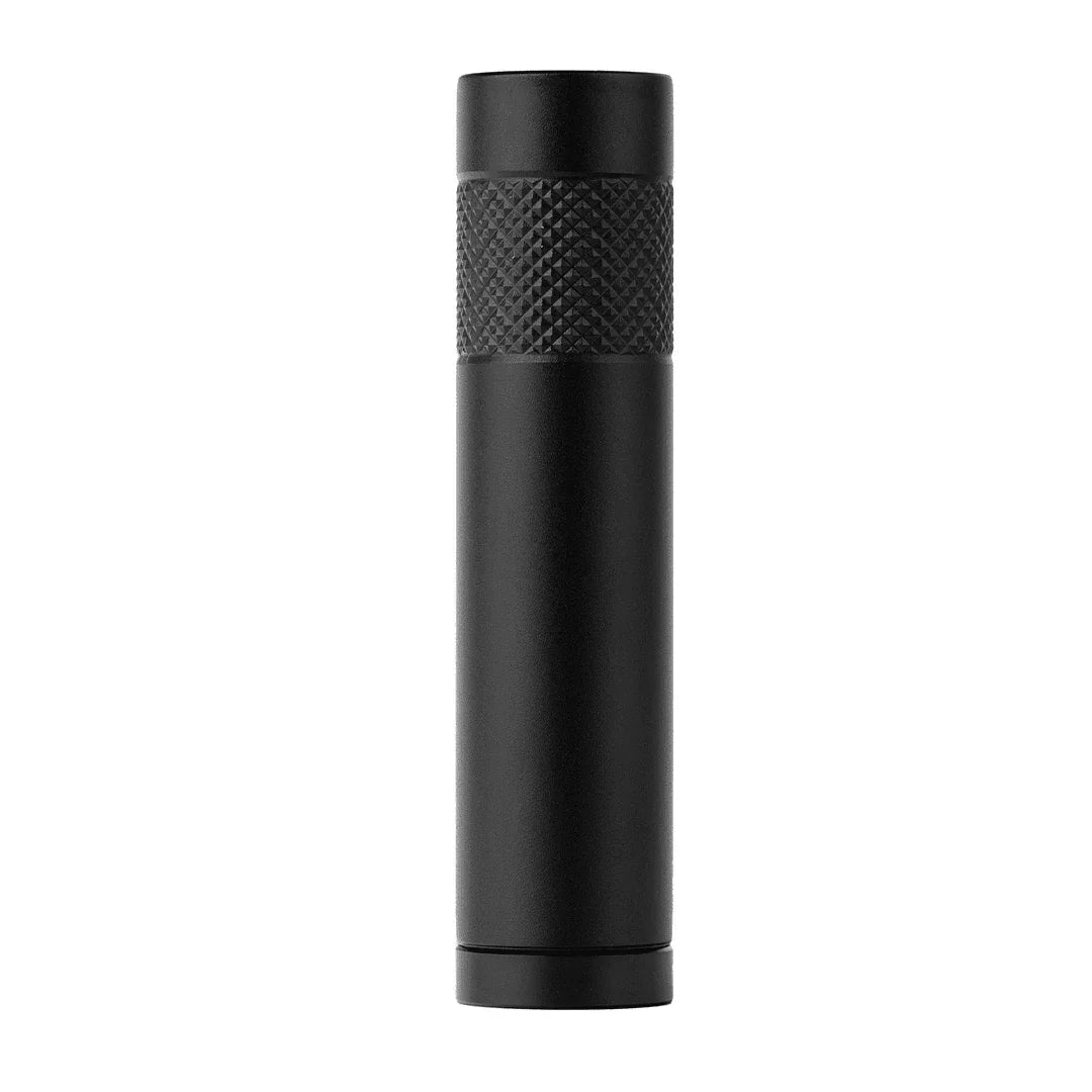 Black metal herb grinder pollen press with textured grip, standing upright on white background