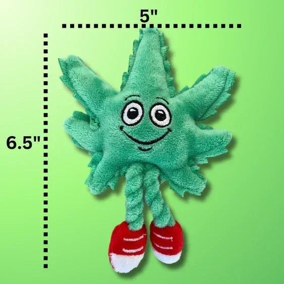 Plush smiling leaf toy with red shoes, 6.5 by 5 inches, on green background
